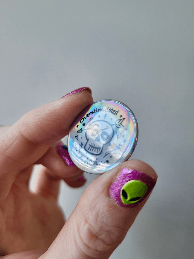 Holographic Overstimulated Again Skull Badge