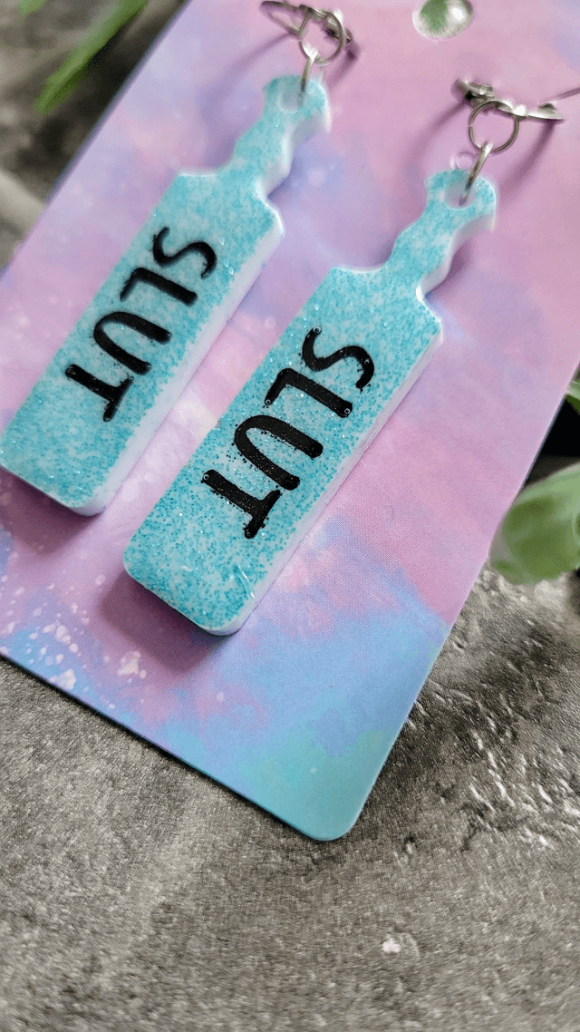 Earrings | SLUT Paddle Earrings Light Blue Glitter on White Base | Stainless Steel Hoops
