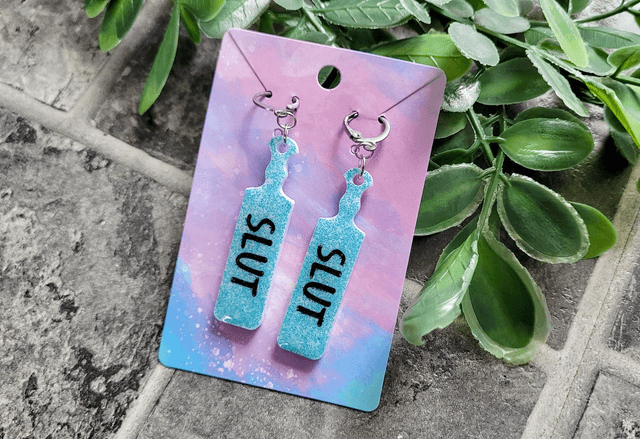Earrings | SLUT Paddle Earrings Light Blue Glitter on White Base | Stainless Steel Hoops